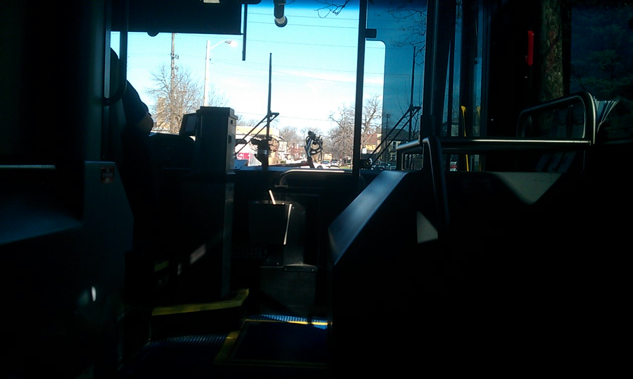 front of the bus with a view of my bicycle handlebars on the bike rack outside